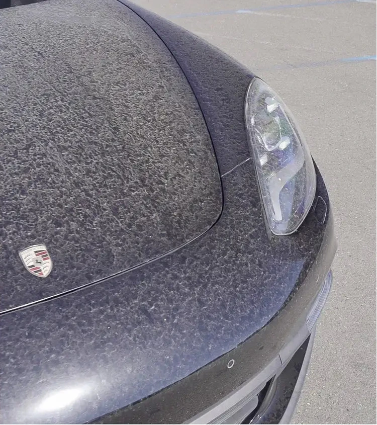 Side-by-side comparison of a Porsche car's headlight with and without water droplets.